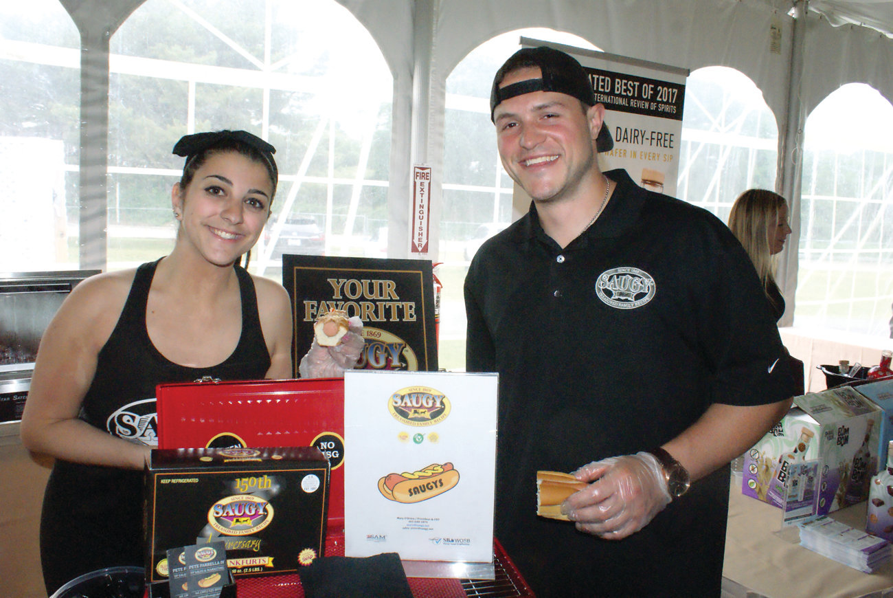 SAY SAUGY: Cousins Gianna and Pete Parrella IV from Saugys in Cranston offer samples of hot dogs during the event.